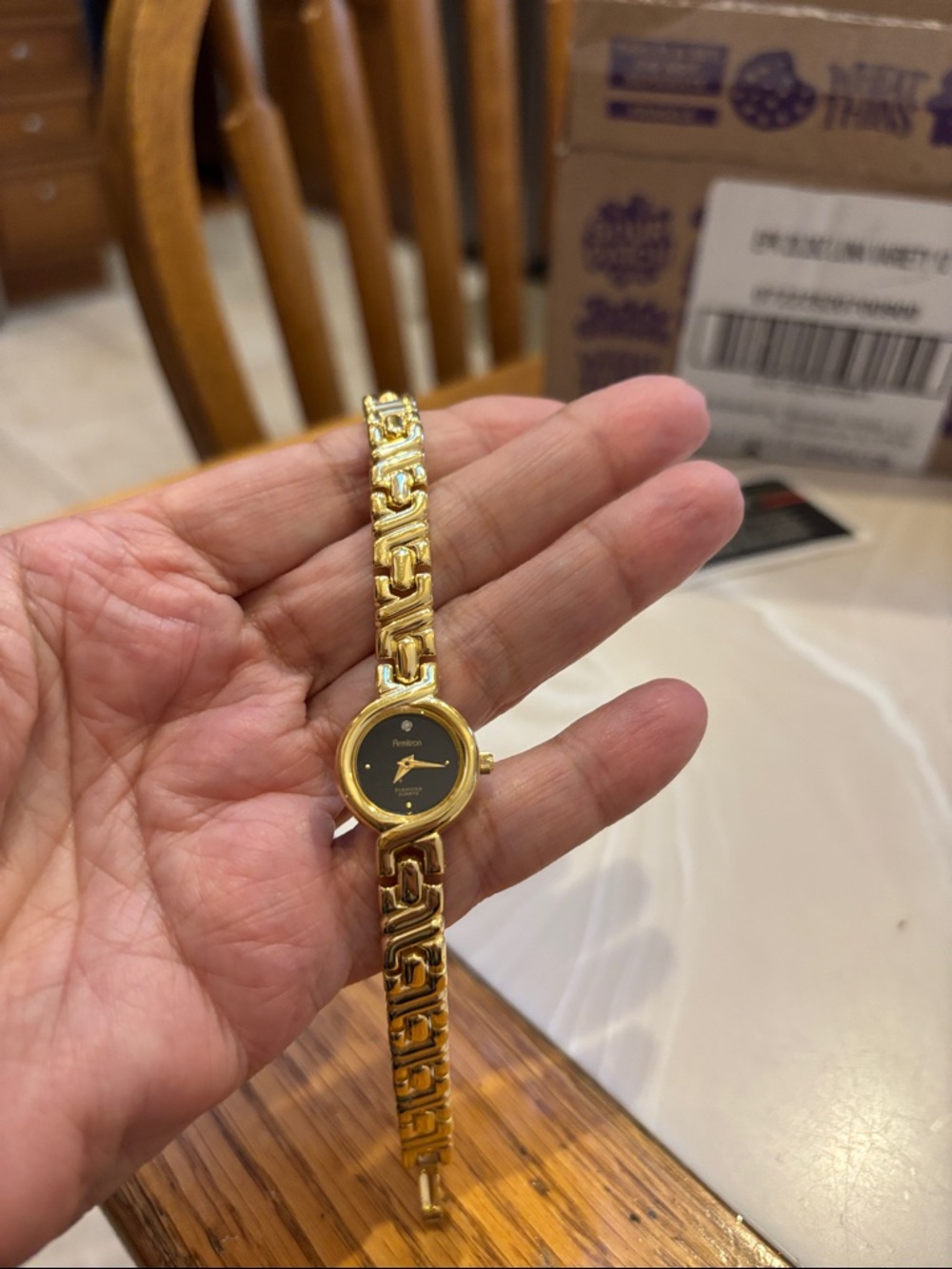 Armitron Gold Tone Bracelet Watch with Black Dial and Diamond chip.